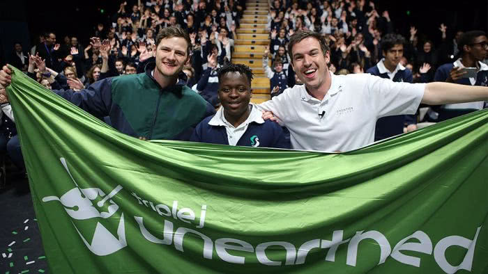 Unearthed High winner Arno Faraji being congratulated by triple j's Ben & Liam