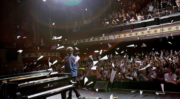 Ben Folds gets bombarded with paper planes onstage