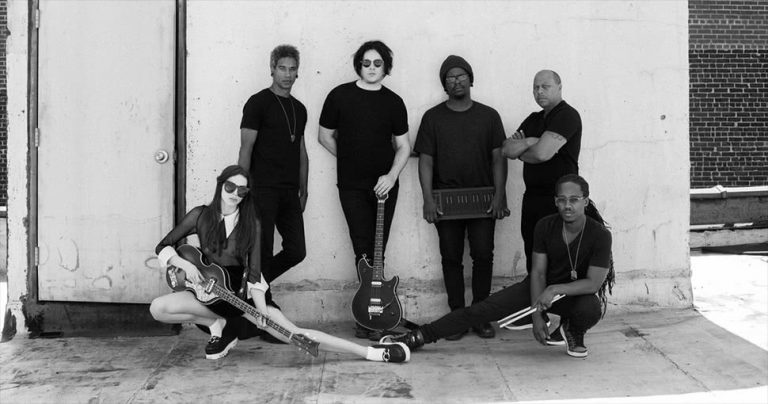 Jack White posing with other musicians while recording his new record