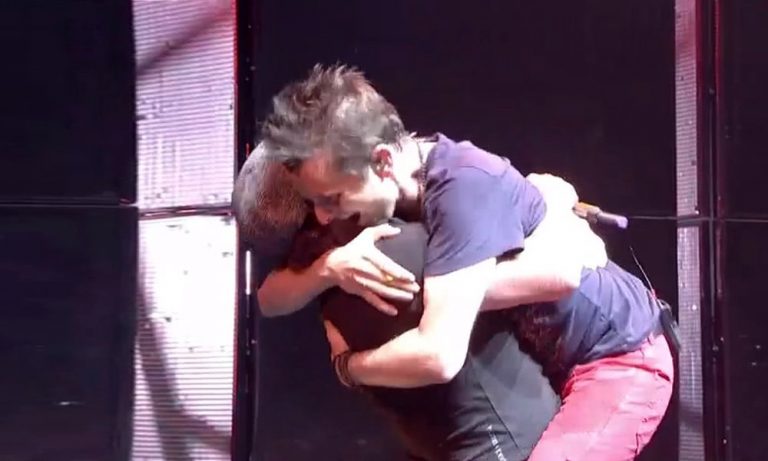 Matt Bellamy hugs Brian Johnson onstage