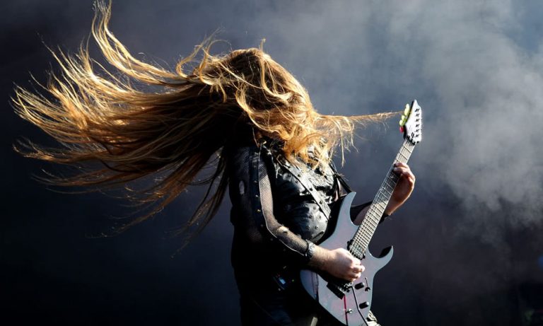 A metal guitarist rocking out onstage