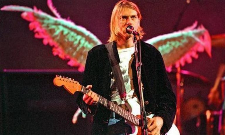 Kurt Cobain live onstage, with angel wings behind him