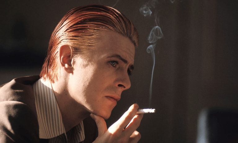 A young David Bowie smokes a cigarette