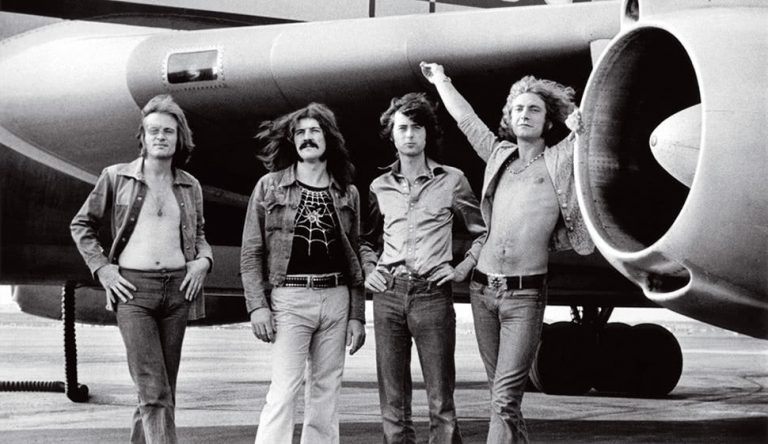 Led Zeppelin standing in front of their famous Starship