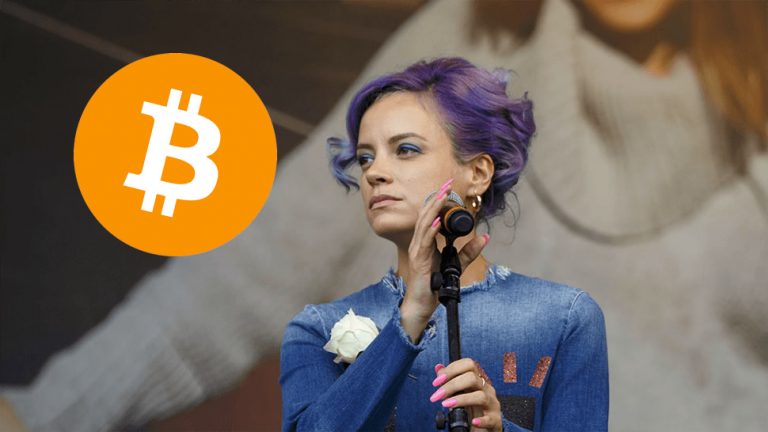 Lily Allen staring wistfully at the logo for cryptocurrency Bitcoin