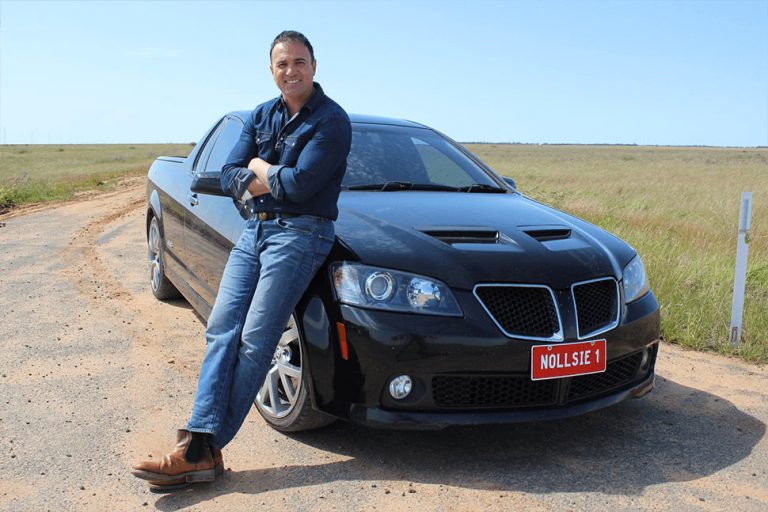 Aussie music legend Shannon Noll, standing by his car.