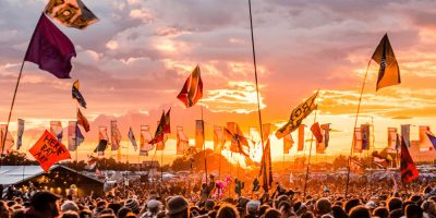 The crowd at Glastonbury festival at sunset