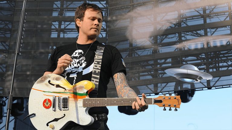 Former Blink-182 guitarist Tom DeLonge pictured with a fake UFO.
