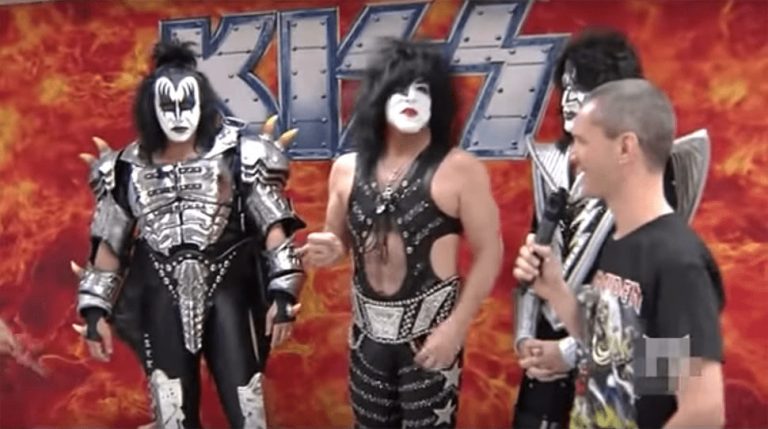Screenshot of an interview in which KISS force an interviewer to remove his Iron Maiden shirt