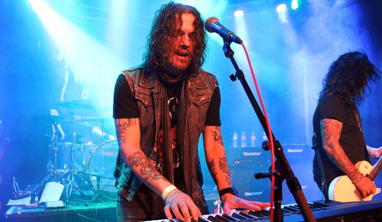 Guns N ' Roses' keyboardist, Dizzy Reed, performing live