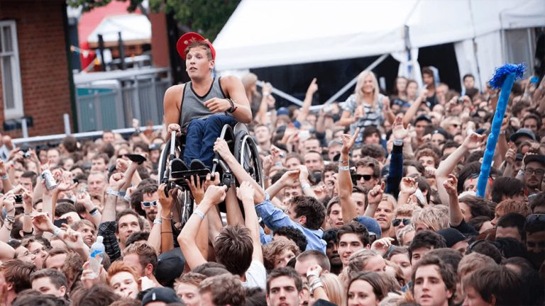 Image of triple j presenter and Paralympian Dylan Alcott crowd-surfing