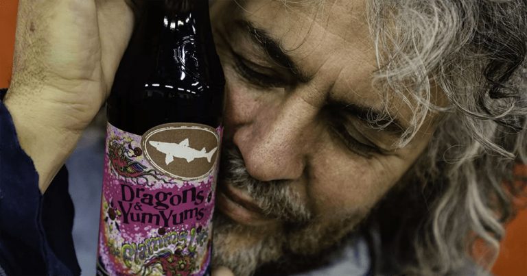 The Flaming Lips' Wayne Coyne with a bottle of Dogfish Head's Dragons & YumYums beer