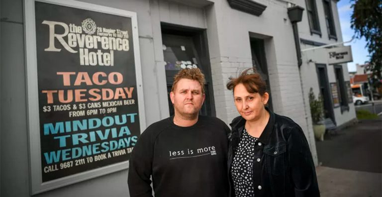 The Reverence Hotel owners Matt Bodiam and partner Melanie in front of a 'Taco Tuesday' sign