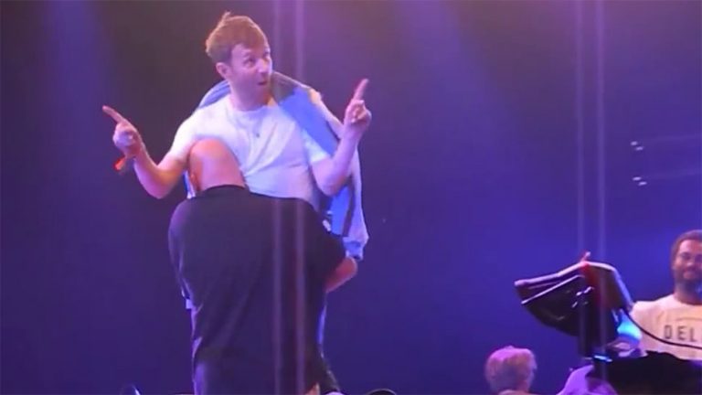 Damon Albarn being carried offstage from an Africa Express performance at Denmark's Roskilde Festival