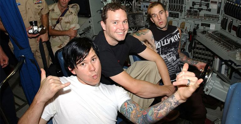 US punk band Blink-182 (Mark Hoppus pictured centre) photographed with US Navy personnel in 2003