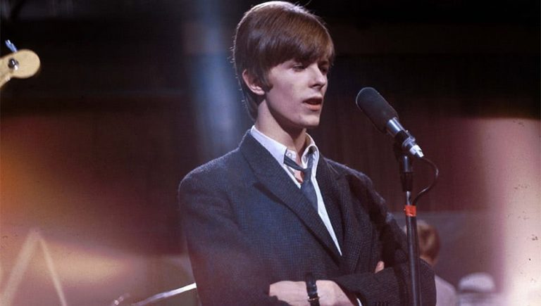A young David Bowie performing live