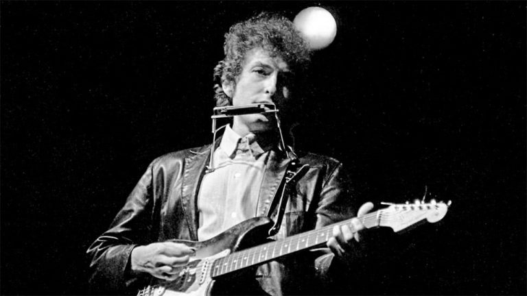 Bob Dylan performing on an electric guitar at the 1965 Newport Folk Festival