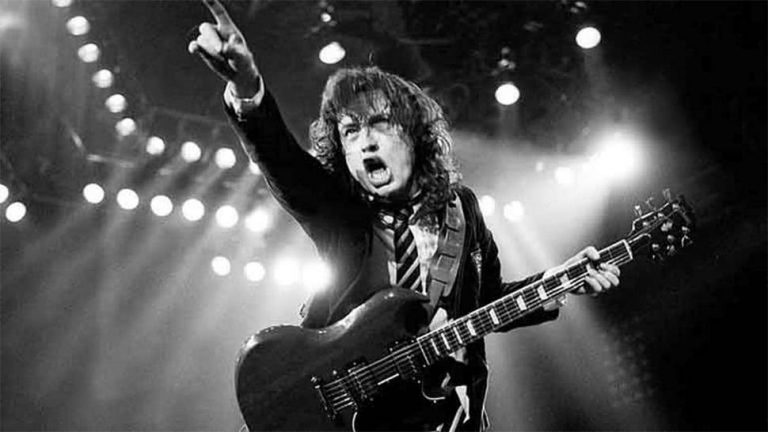 Angus Young of AC/DC playing guitar