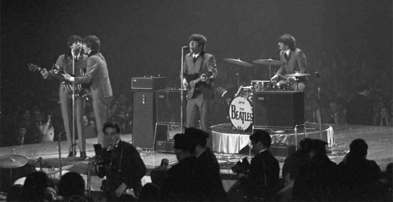 The Beatles performing at thir final paying concert in August of 1966