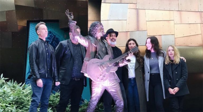 Seattle's Chris Cornell statue, flanked by his family members and Soundgarden bandmates