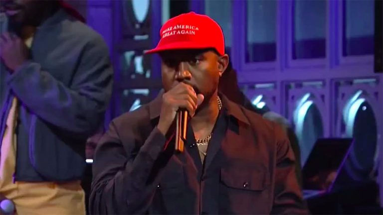 Kanye West performing while wearing a 'Make America Great Again' hat