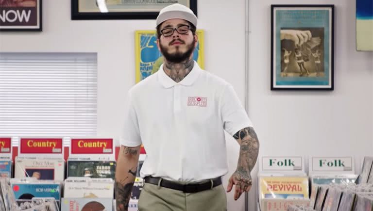 Post Malone dressed as a record store employee