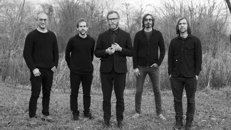 Members of US rock band The National in a forest.