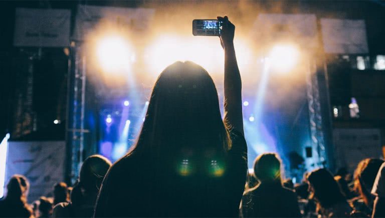 Image of people using their phones at a live show