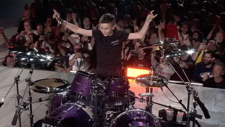 Image of 13-year-old Evan Adamson sitting in as the drummer for Metallica in Amsterdam