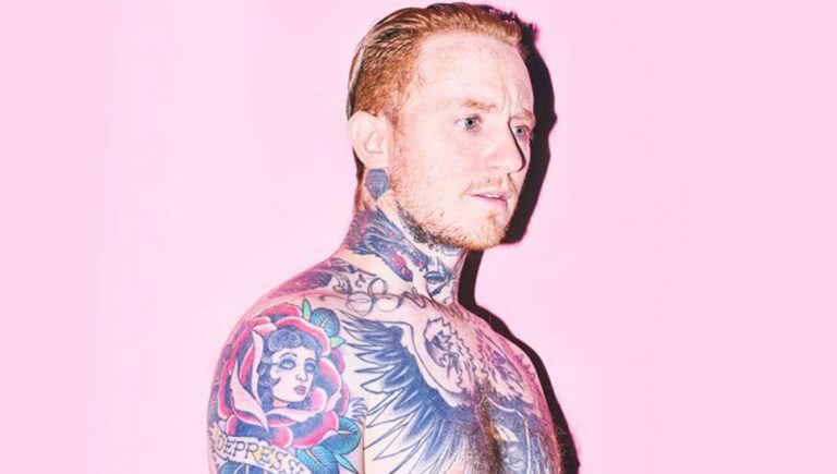Portrait of Frank Carter in front of a pink background