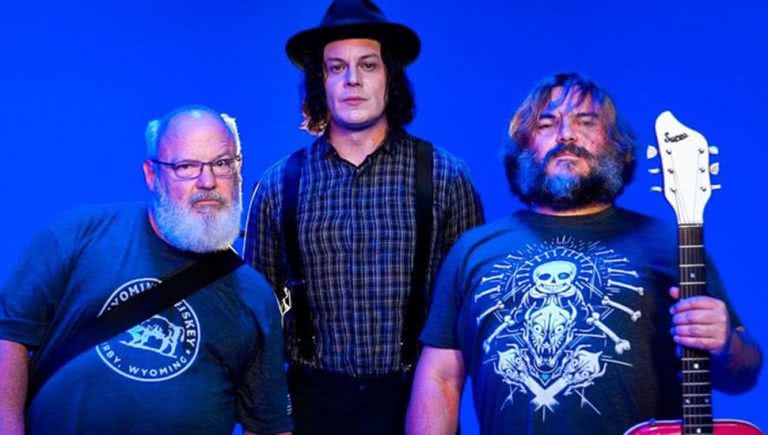 Photo of Jack Black and Kyle Gass of Tenacious D and Jack White against a blue backgtround