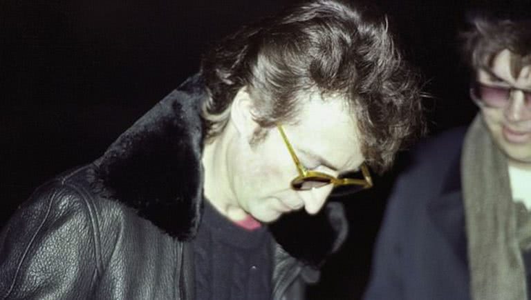 Photo of John Lennon signing and autograph for Mark Chapman