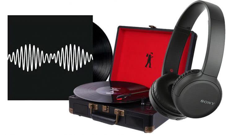 An arctic monkeys record, a record player and headphones