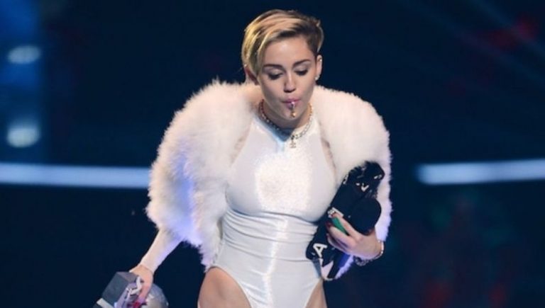 Musician Miley Cyrus smoking weed on stage