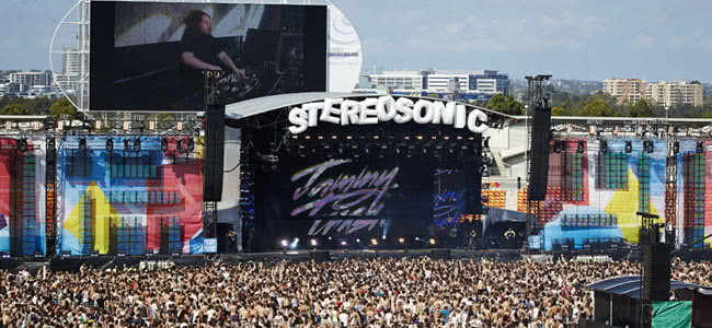 Large crowd standing infant of a stage at the stereosonic festival