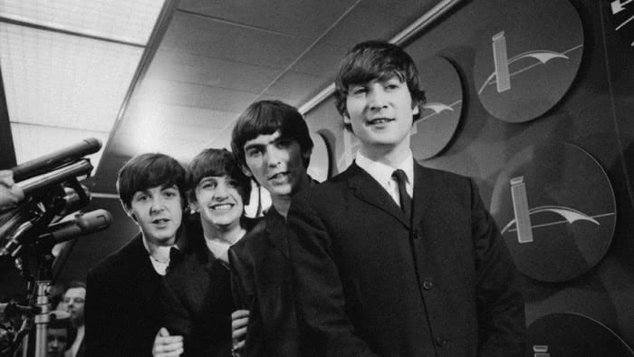 A portfolio of unseen Beatles photos has sold for £250,000 at an auction